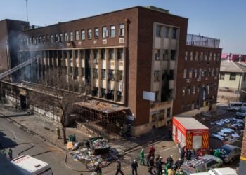 At least 74 dead after fire tears through building used as temporary housing in South Africa