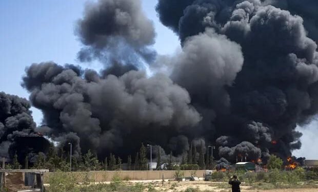 Flames engulf the fuel tanks of the only power plant in the Gaza Strip after it was hit by Israeli