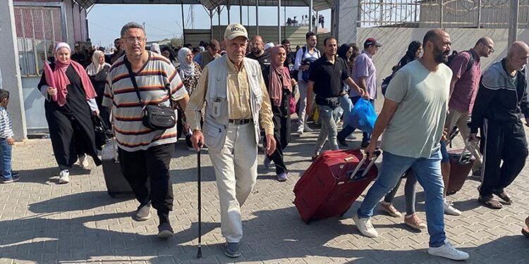 Palestinians with dual citizenship walk at the Rafah border crossing with Egypt, in the hope of getting permission to leave Gaza, amid the ongoing conflict between Israel and Palestinian Islamist group Hamas, in Rafah in the southern Gaza Strip, November 1, 2023. REUTERS/Arafat Barbakh