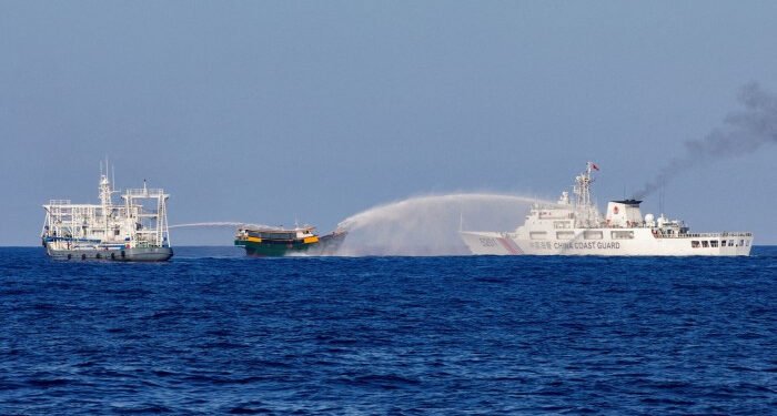 Chinese coast guard vessels fire water cannons towards a Philippine vessel that was on its way to a resupply mission at Second Thomas Shoal in March; Photo: Reuters