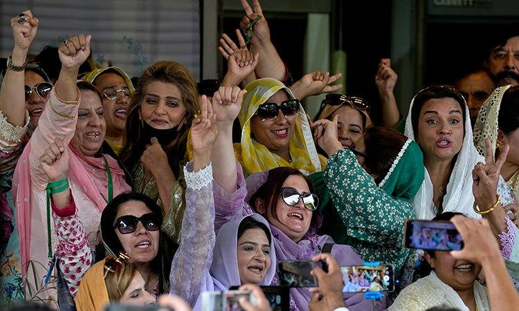 Supporters of former PM Imran Khan's party PTI, react after a Supreme Court decision in a case of reserved seats for women and minorities in the parliament. | Photo: Social Media