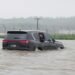 Kim Jong Un drives into deep flood in car